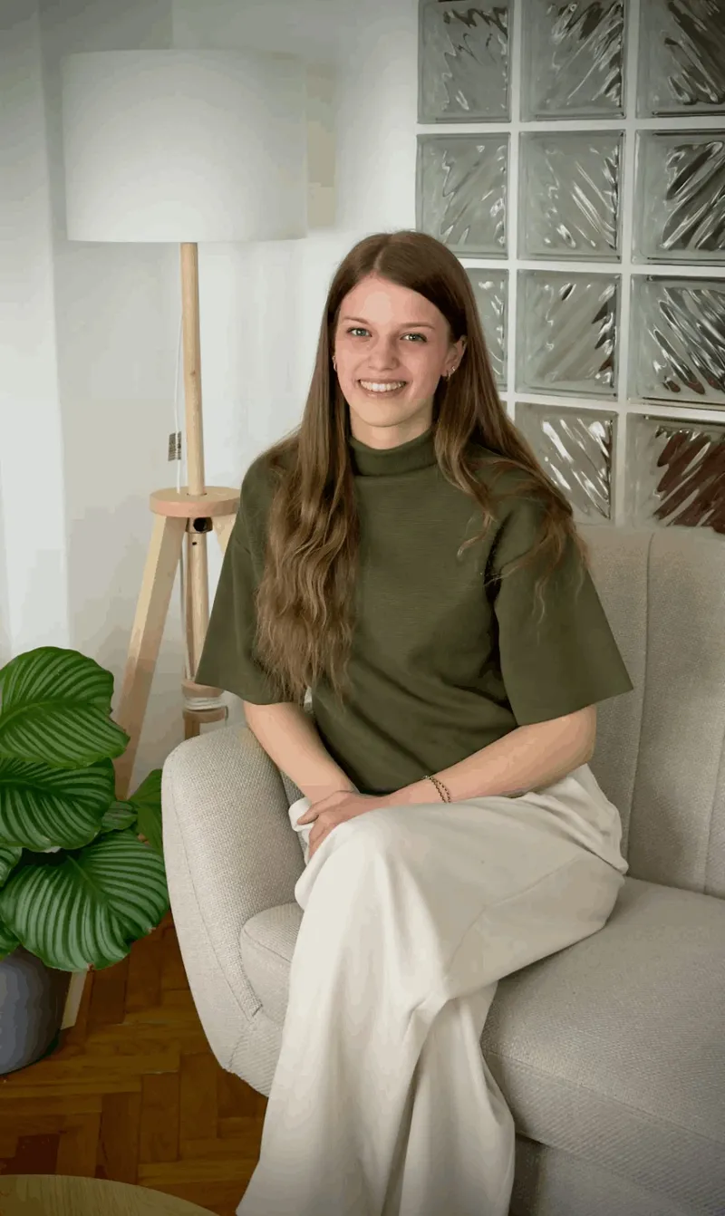 Vivi in a green jumper, smiling